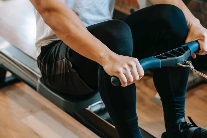 man using rowing machine