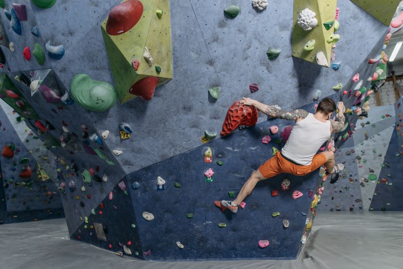Male rock climber on indoor boulders