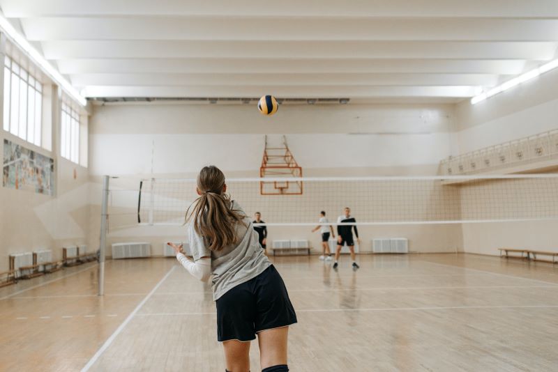 young women playing volleyball